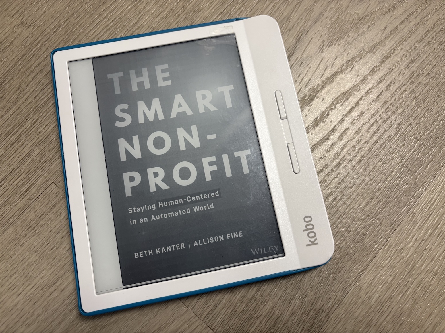 An e-reader displays the cover of the book "The Smart Nonprofit".
