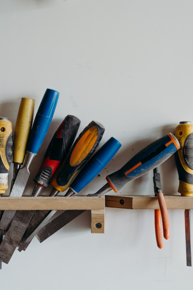 A wall with various tools on it.